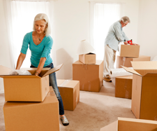 Image of an elderly couple unpacking boxes in their new apartment