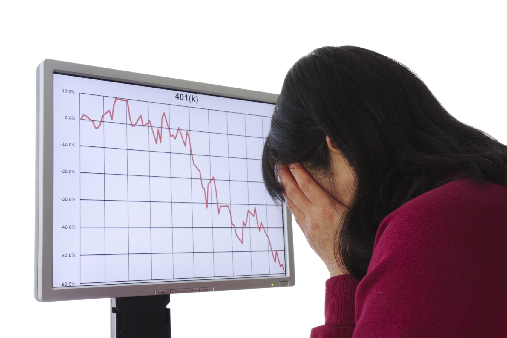 upset woman is holding her head in front of the monitor showing a drop in market