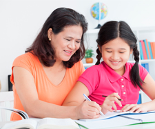 Mother helping her daughter with her home-work