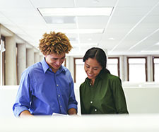 coworker showing document to another colleague