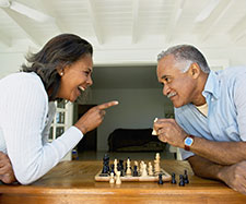 old couple is enjoying a game of chess