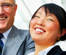 Image of a man and a woman professional with wide smiles